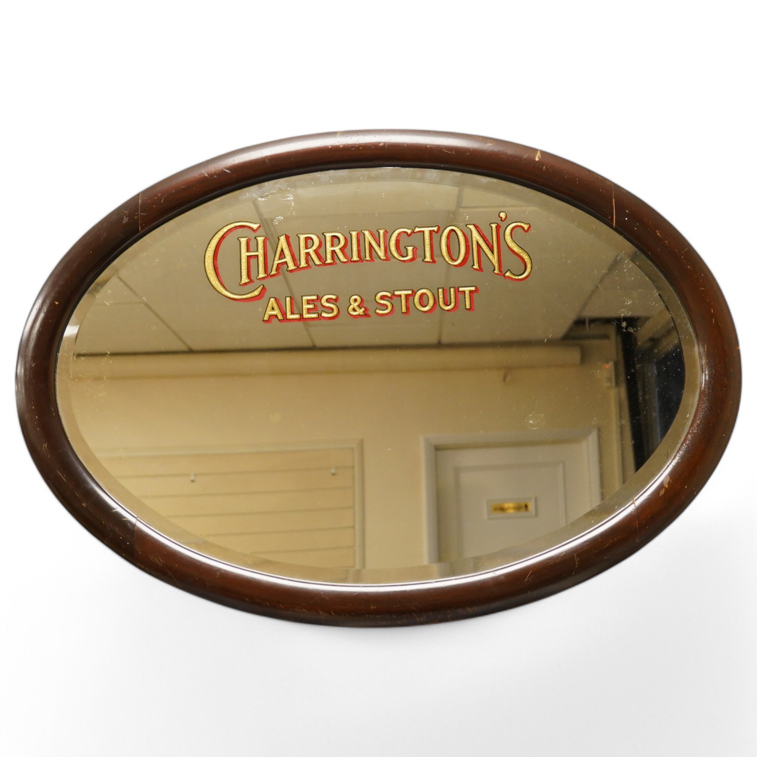 A Charrington's Ale & Stout mahogany framed oval mirror, 86cm wide. Condition - fair